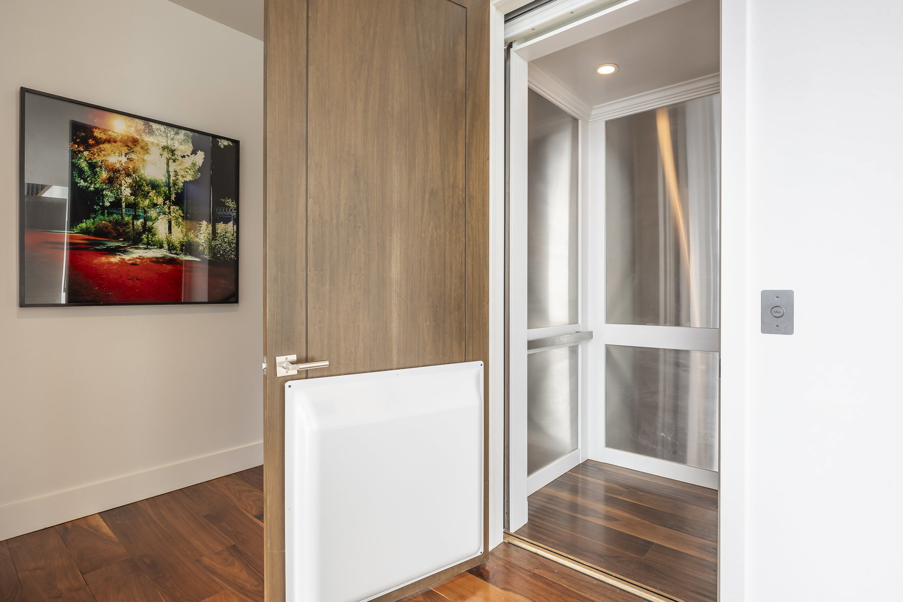 Residential elevator with a stainless steel interior and recessed lighting