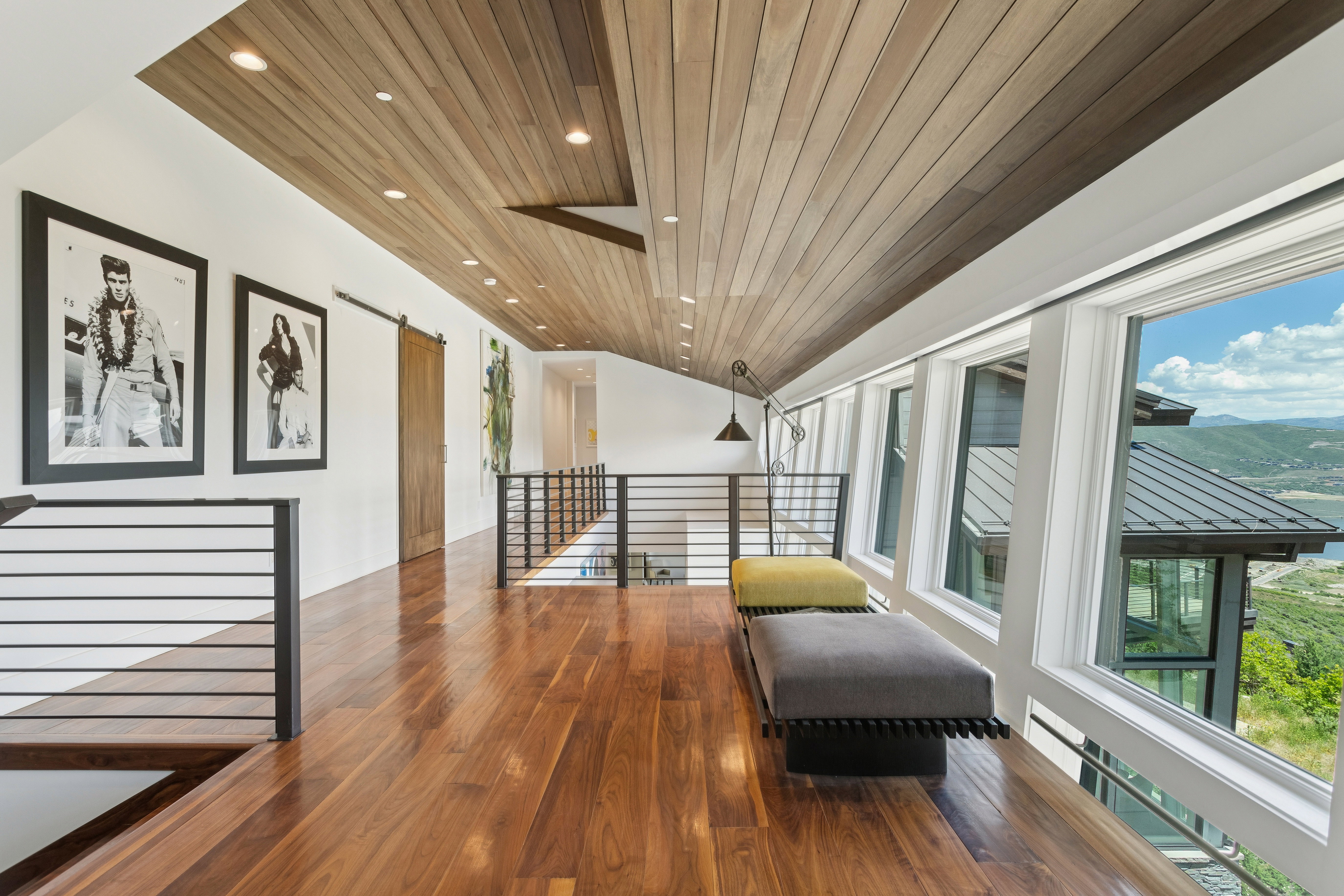 Hardwood flooring and wood-paneled ceiling with recessed lighting