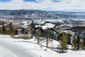 Modern sloped-roof architecture featuring dark siding and expansive windows