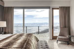 Floor-to-ceiling sliding glass doors open to an outdoor patio with a metal railing
