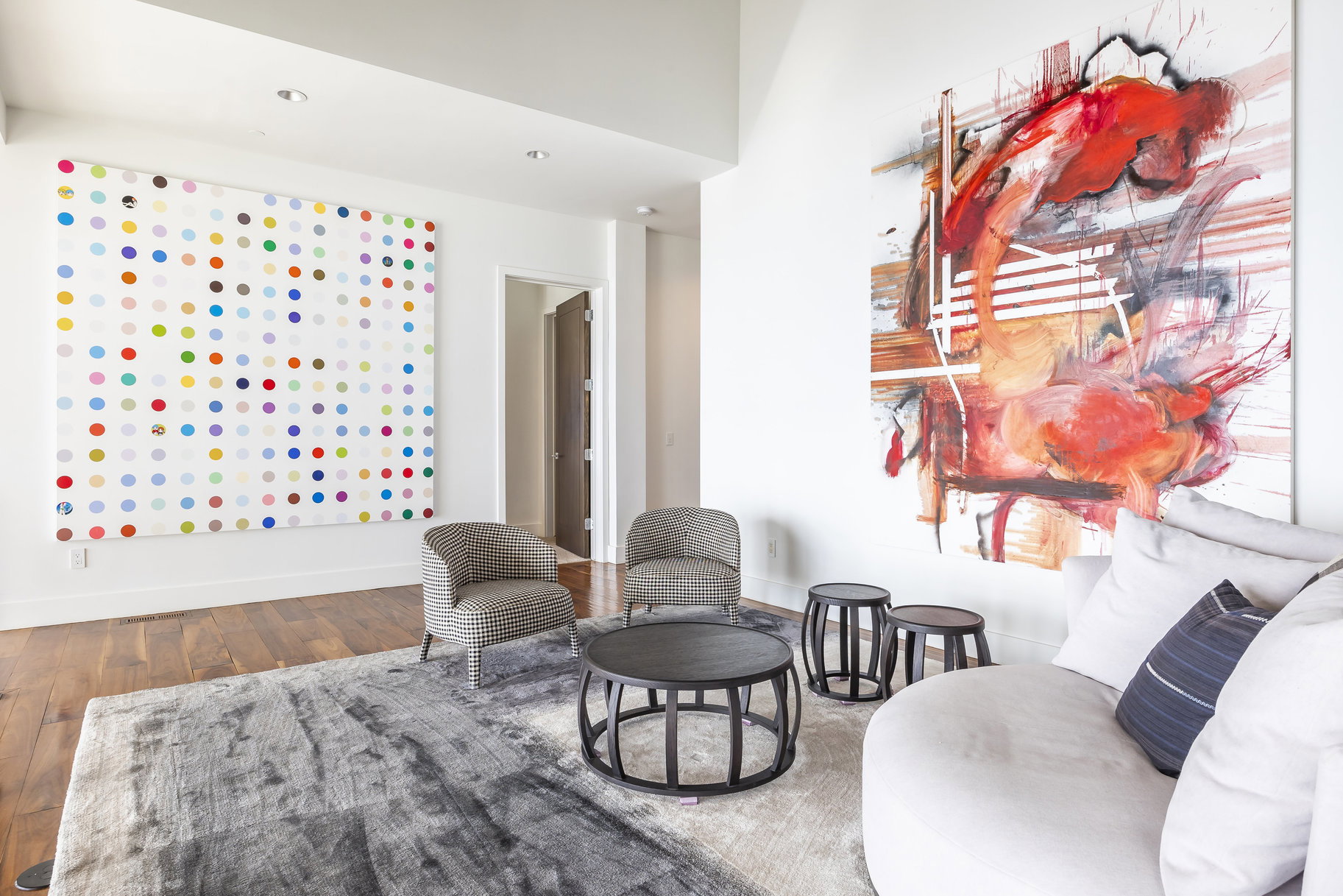 Spacious living area featuring high ceilings, recessed lighting, and wood-finish flooring