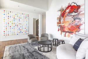 Spacious living area featuring high ceilings, recessed lighting, and wood-finish flooring