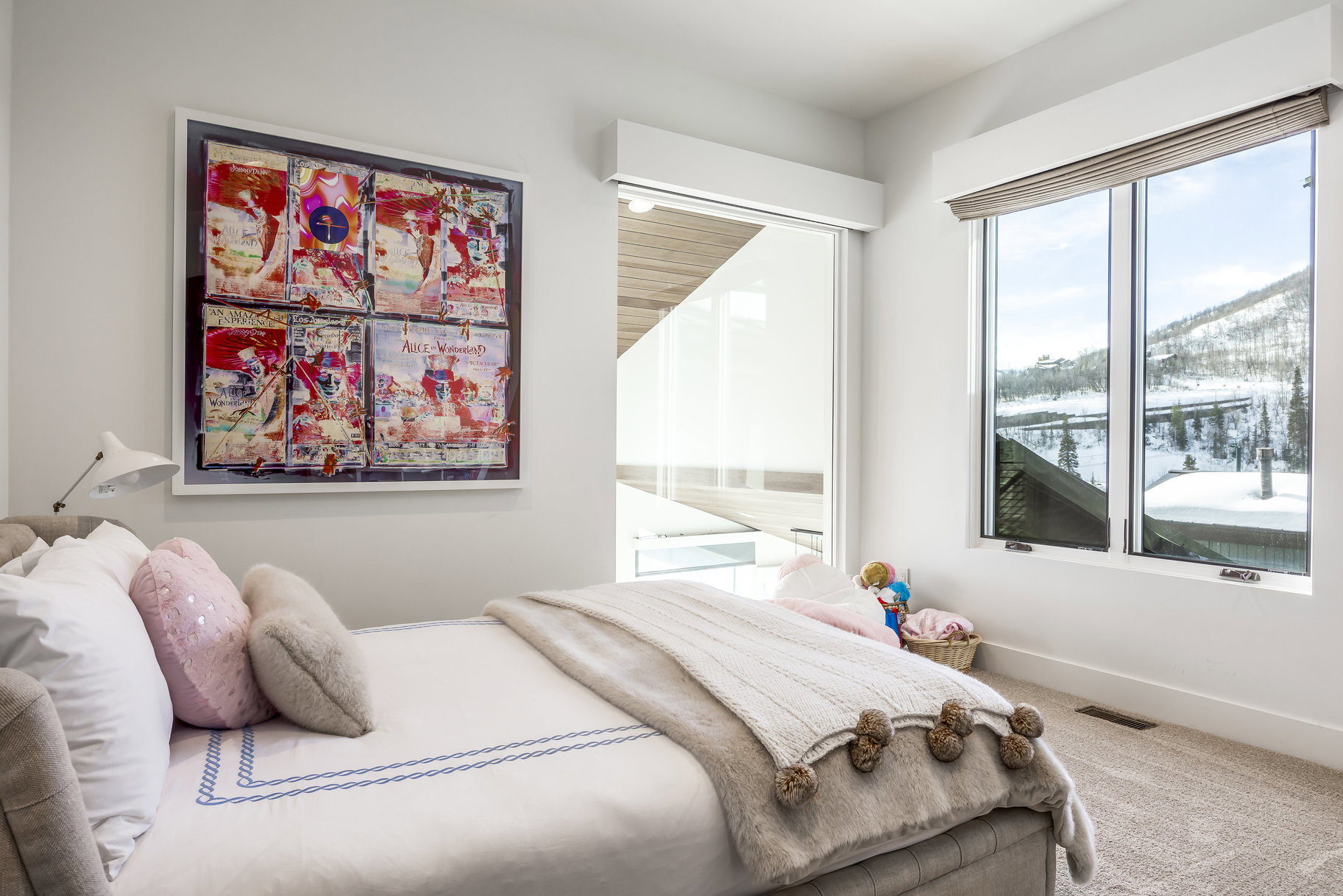 Bedroom featuring large windows, white walls, and light-colored carpeting