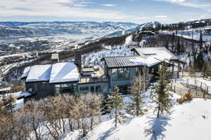 Mountain-side residence featuring a multi-level design and a metal roof