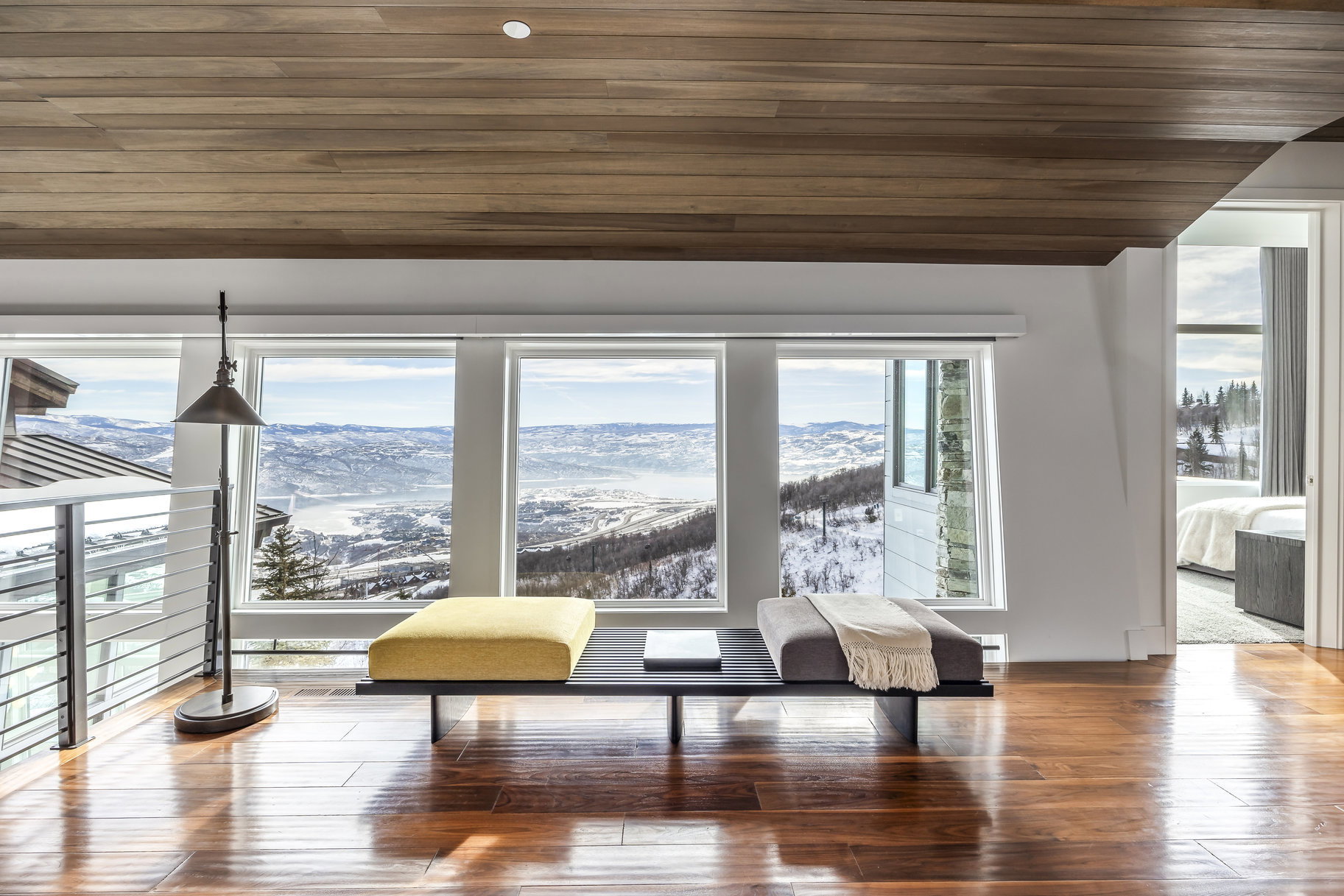 Panoramic window array showcasing a distant mountain and valley landscape