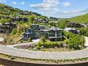 Contemporary residence featuring a multi-level design, extensive glazing, and stone facade elements