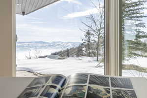 Expansive window framing a snow-covered mountain landscape