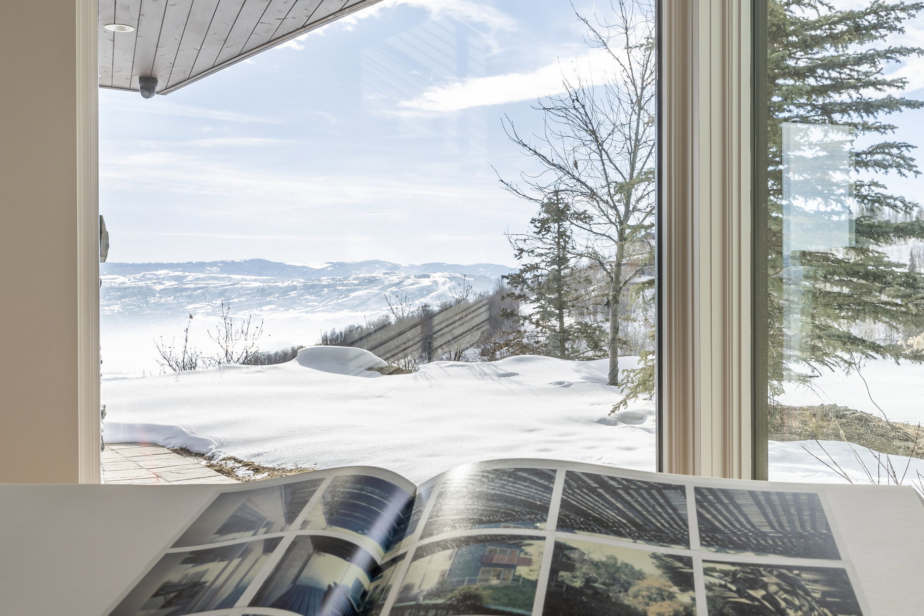 Expansive window framing a mountain and valley landscape