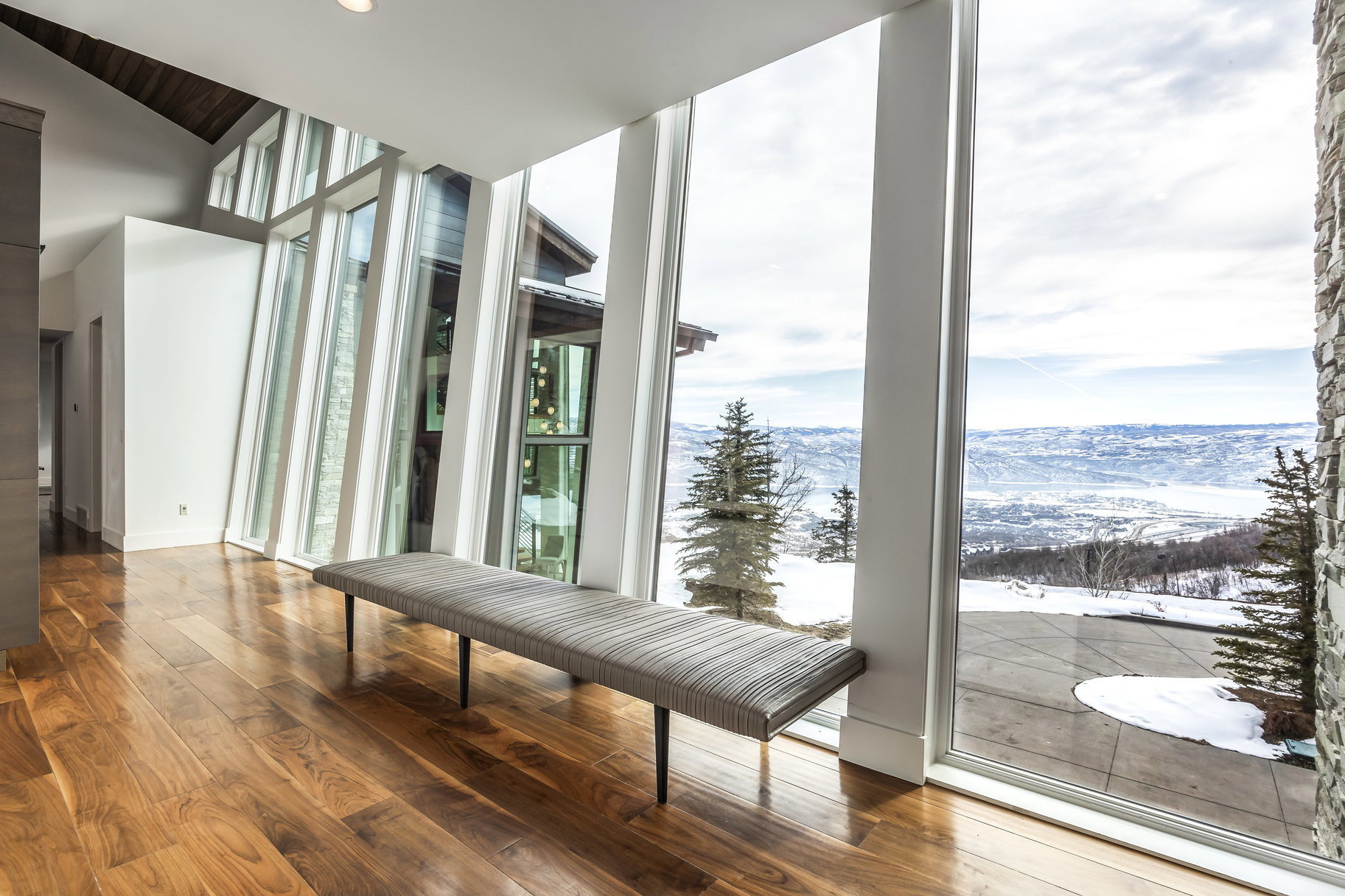 Expansive floor-to-ceiling windows featuring mountain and valley scenery
