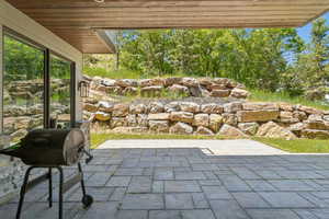 Covered patio featuring paver flooring and recessed lighting