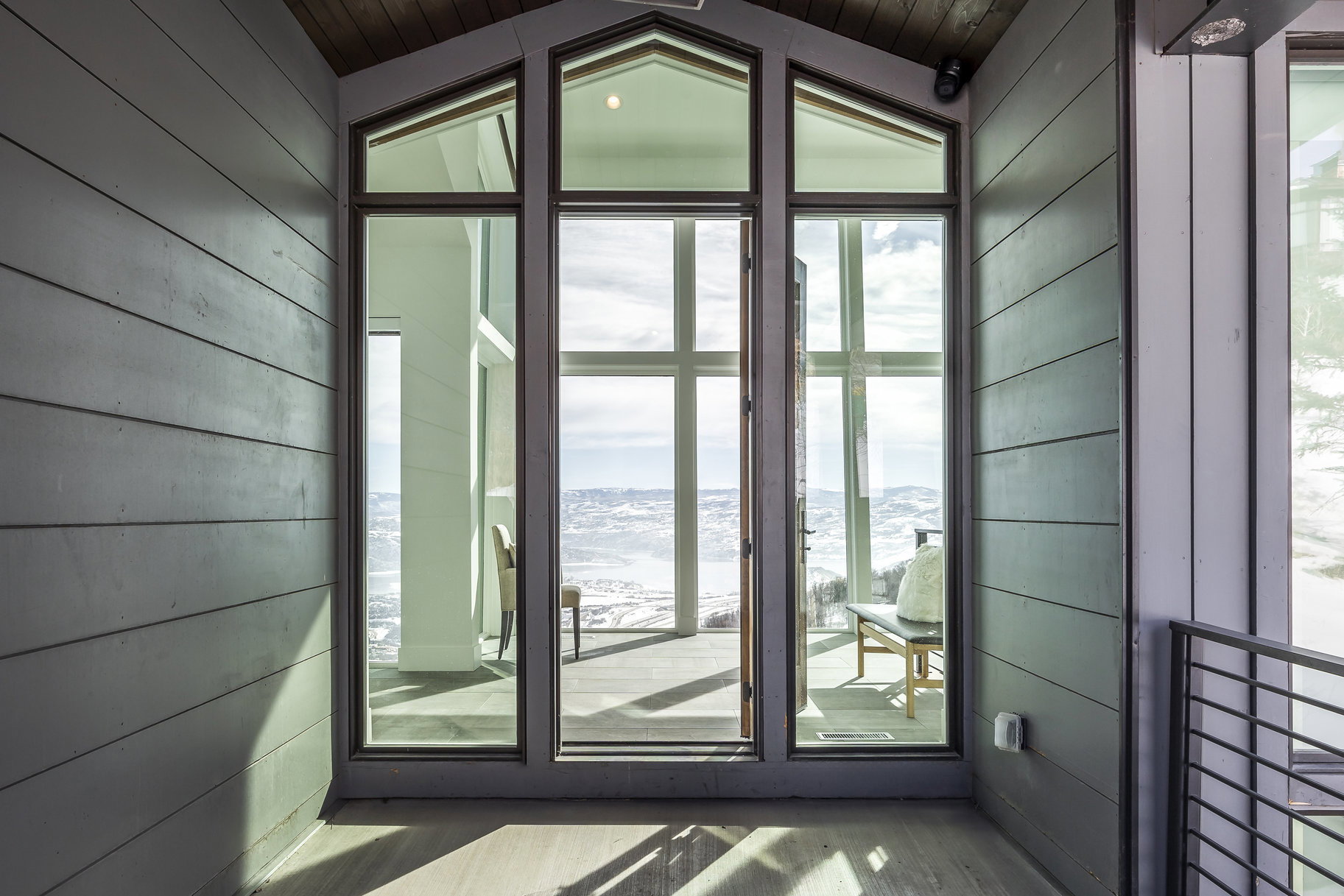 Expansive window wall with trapezoid transom panels