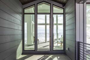 Expansive window wall with trapezoid transom panels