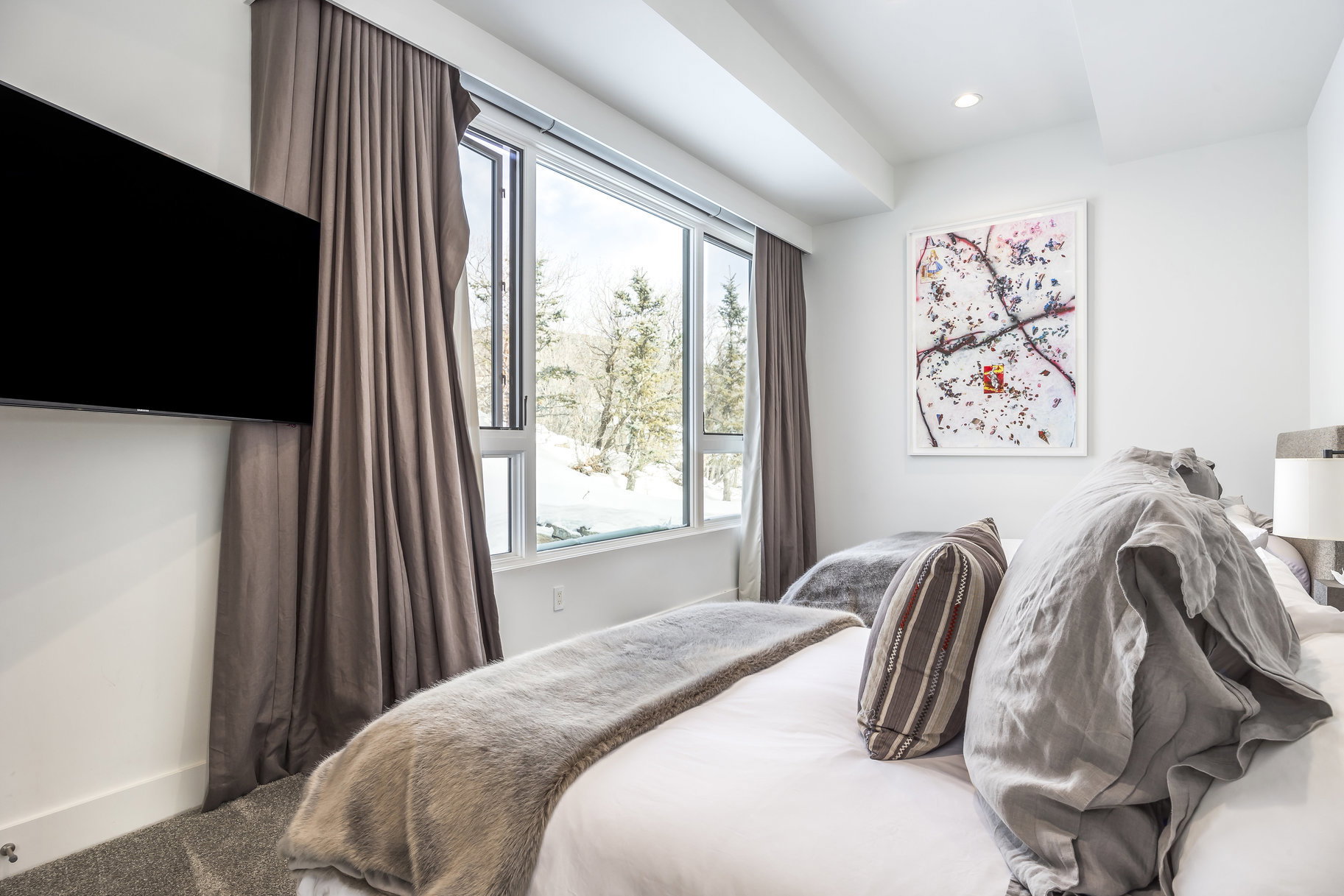 Spacious room featuring a large picture window with outdoor scenery, recessed lighting, and a wall-mounted flat-screen television
