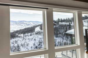 Expansive windows showcasing panoramic mountain scenery and snow-covered slopes