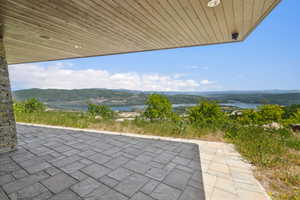 Expansive outdoor patio area featuring stamped concrete flooring and a wood-finish ceiling