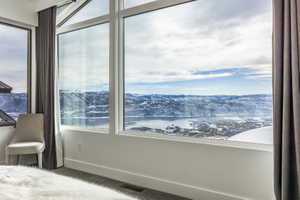Floor-to-ceiling windows with expansive mountain and lake scenery