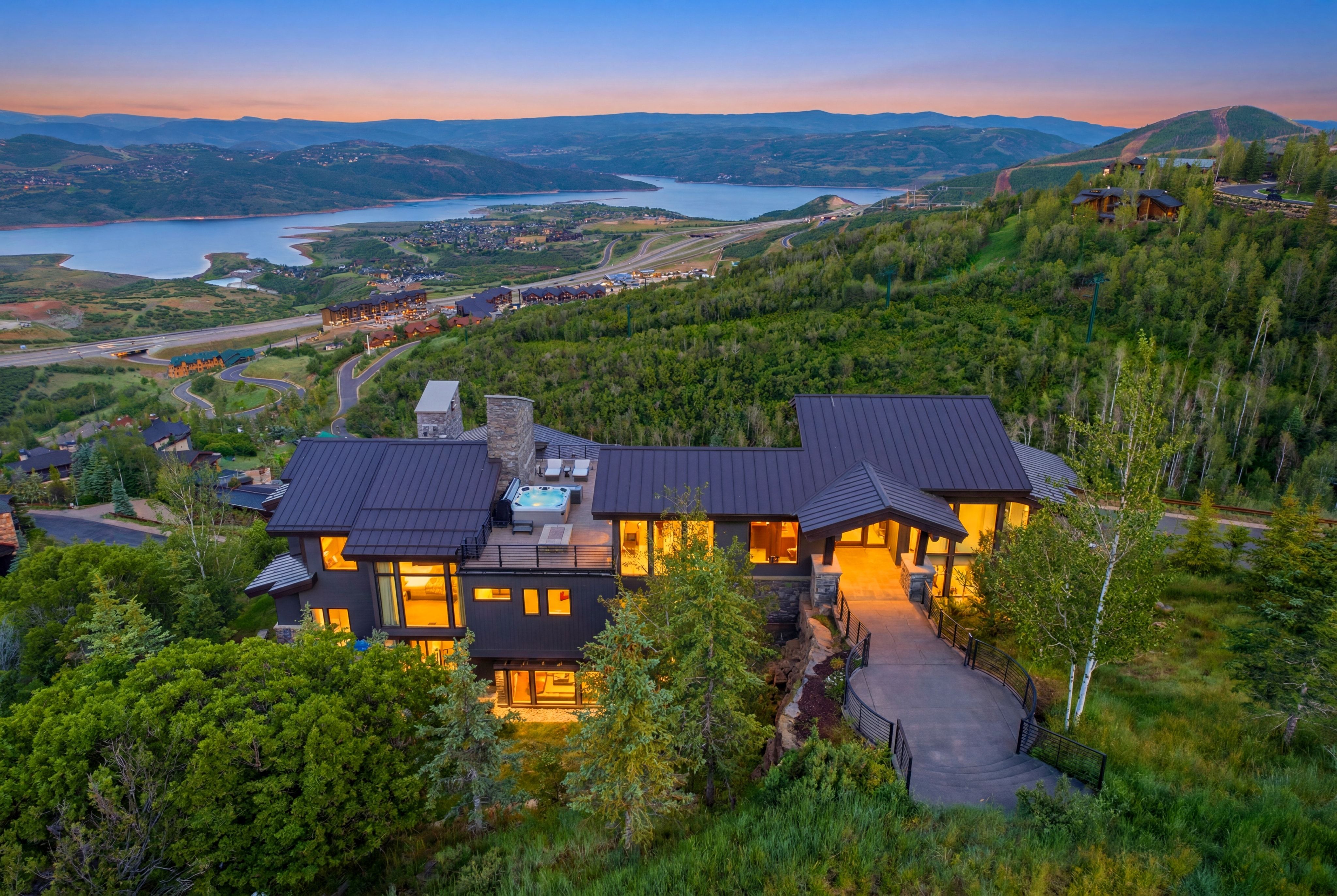Hillside residence featuring a multi-level design and dark metal roofing