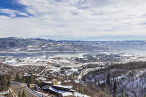 Expansive mountain and lake scenery featuring snow-dusted terrain