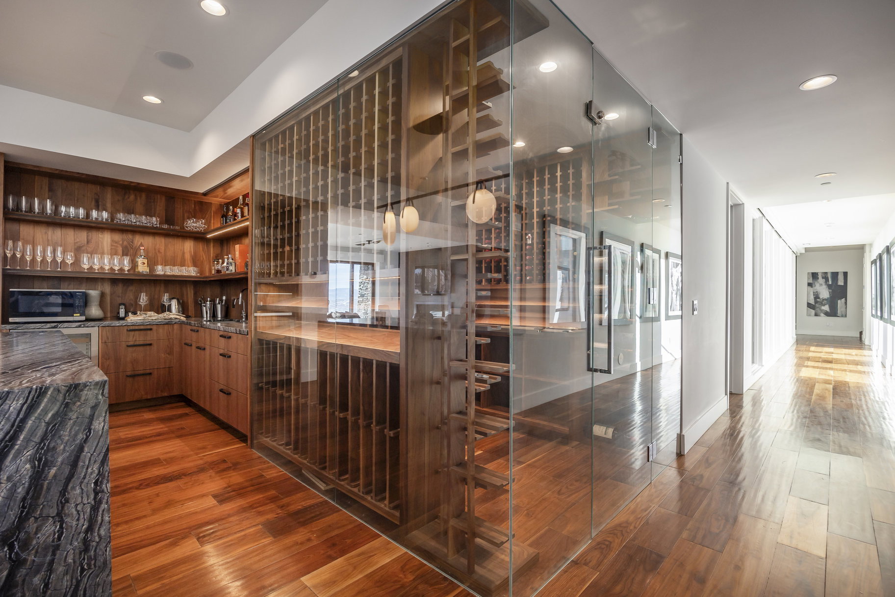 Custom glass-enclosed wine cellar with a wood-finish interior