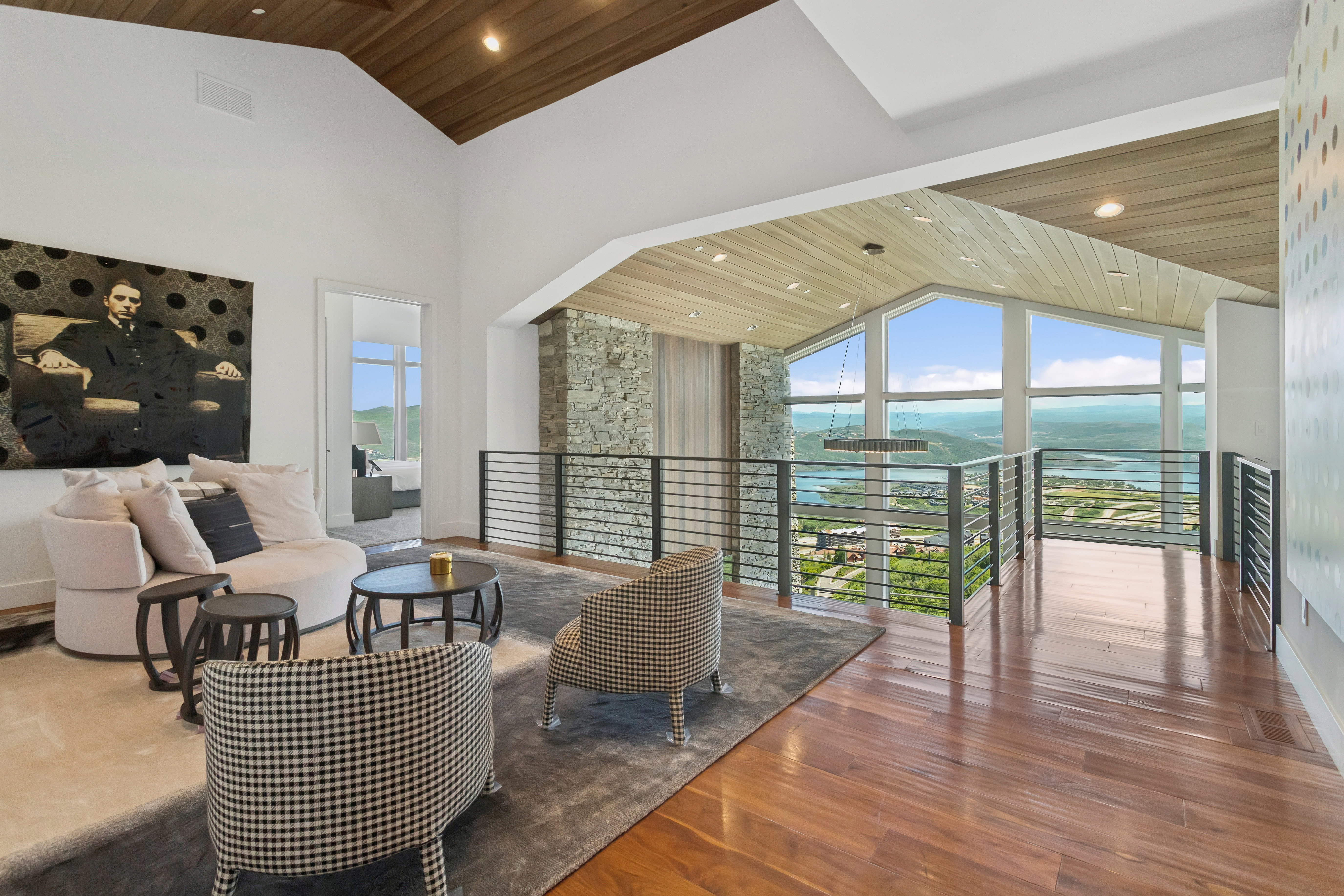 Vaulted wood-paneled ceilings over an open-concept living area with wood-finish flooring