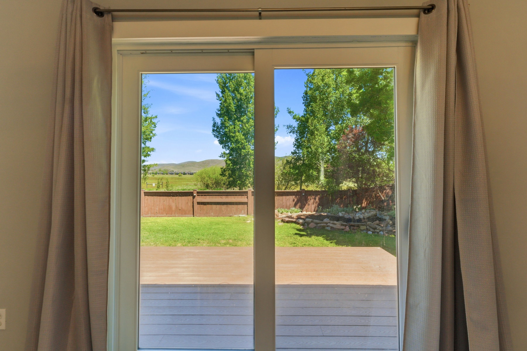 Sliding glass door leading to an outdoor deck