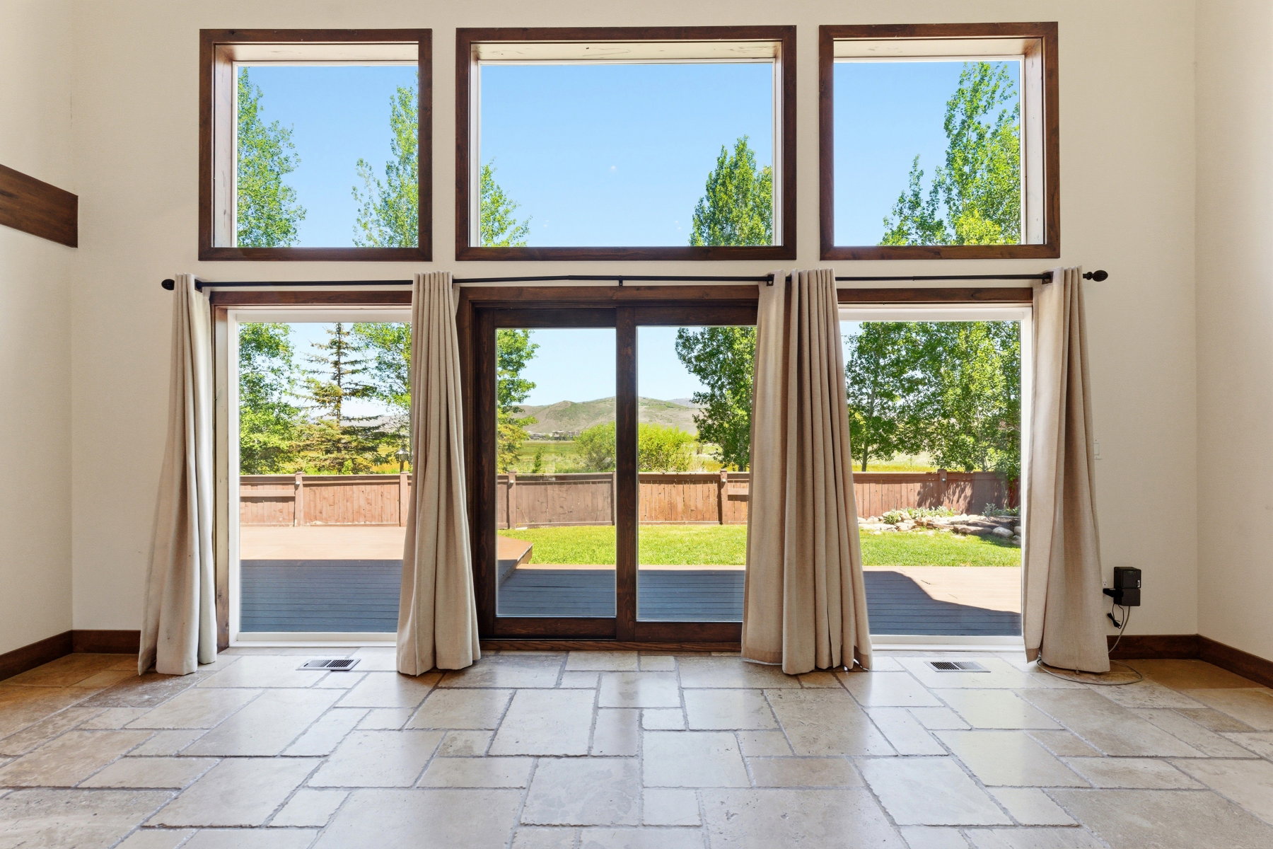 Expansive window wall with multiple large windows and a glass door providing abundant natural light