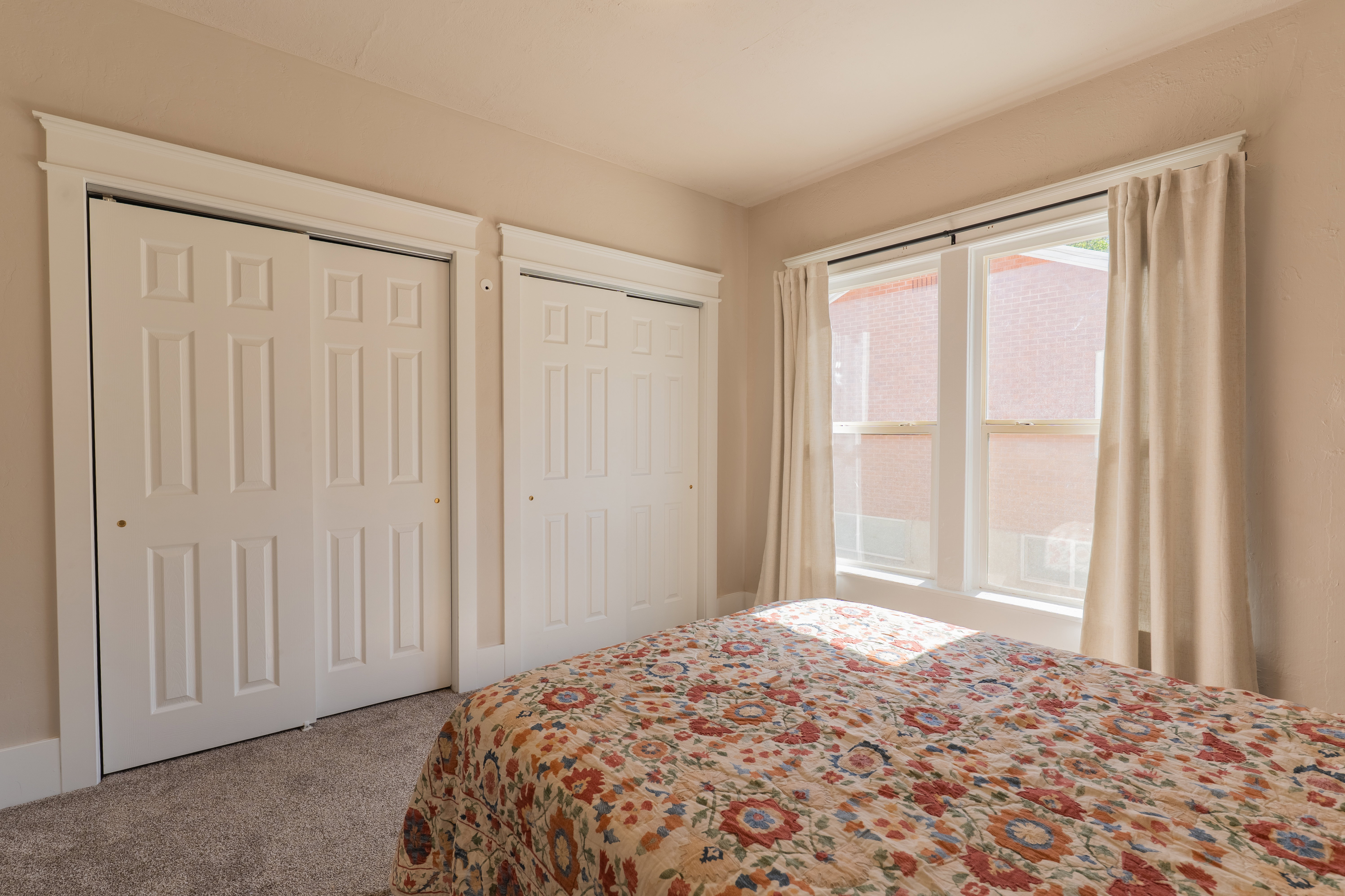 Recessed double-panel sliding closet doors with white trim and crown molding