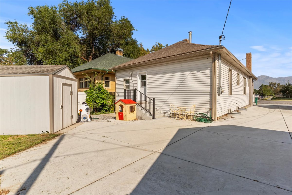 Expansive concrete driveway and outdoor storage shed