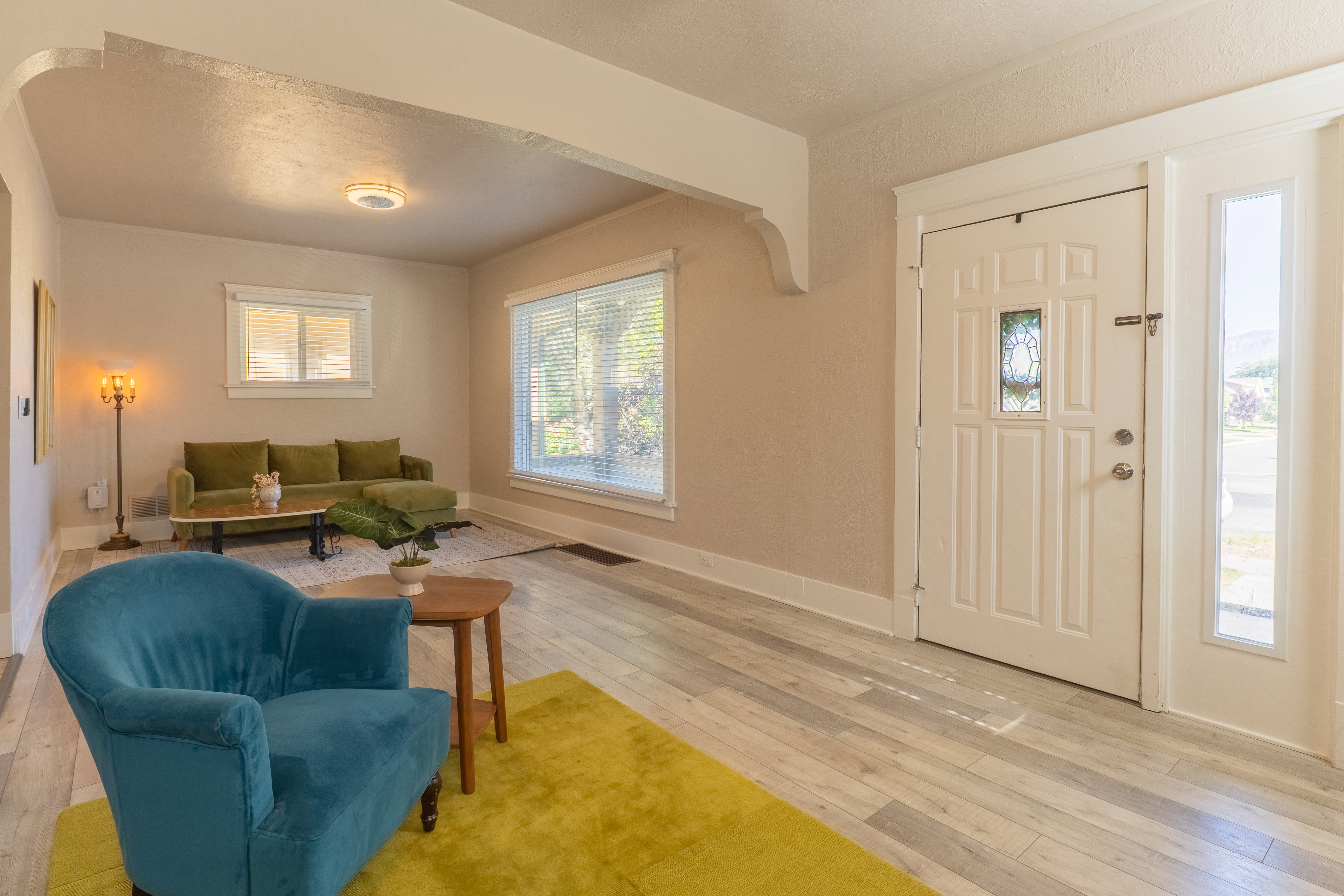 Entryway featuring a white paneled door with decorative glass inserts and a sidelight