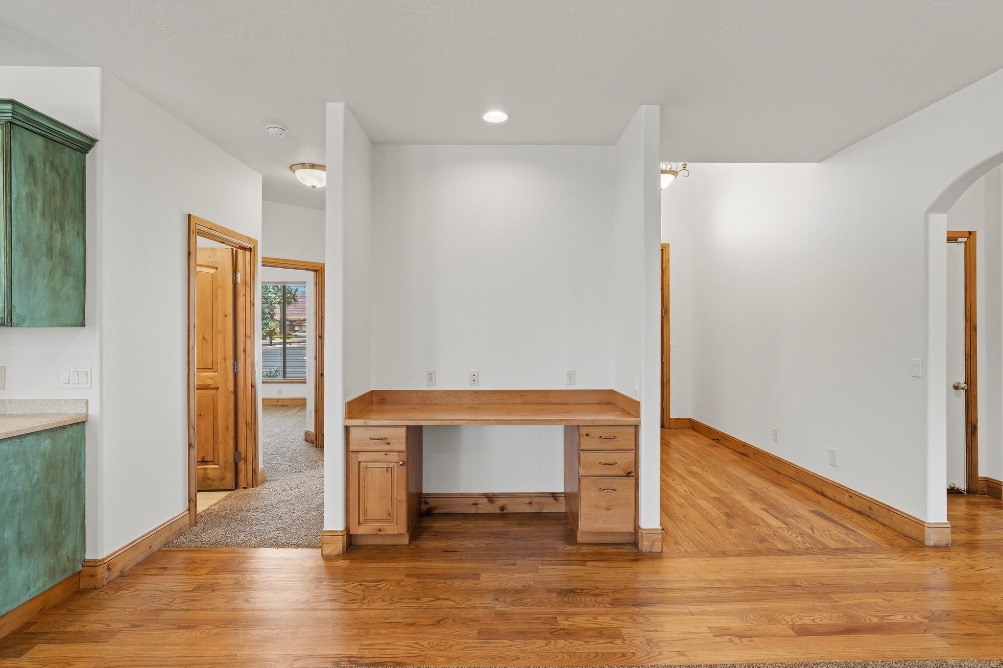 Built-in desk featuring wooden cabinetry and a light wood-finish countertop