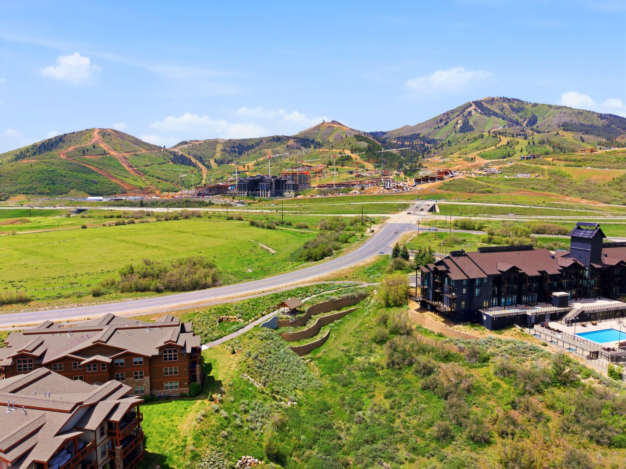 Mountain landscape featuring multiple residential buildings with dark roofs and wood-clad exteriors