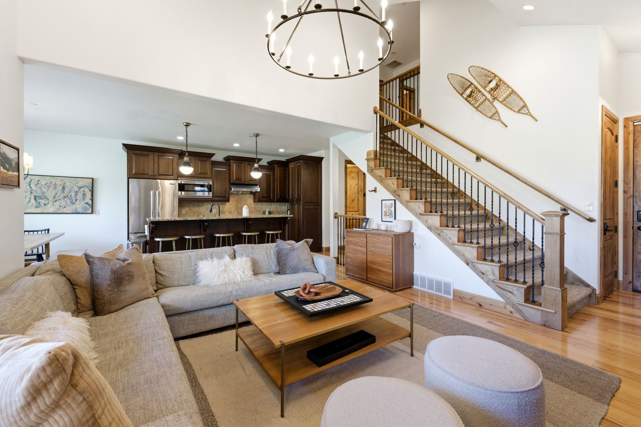 Open-concept living area featuring high ceilings and wood-finish flooring