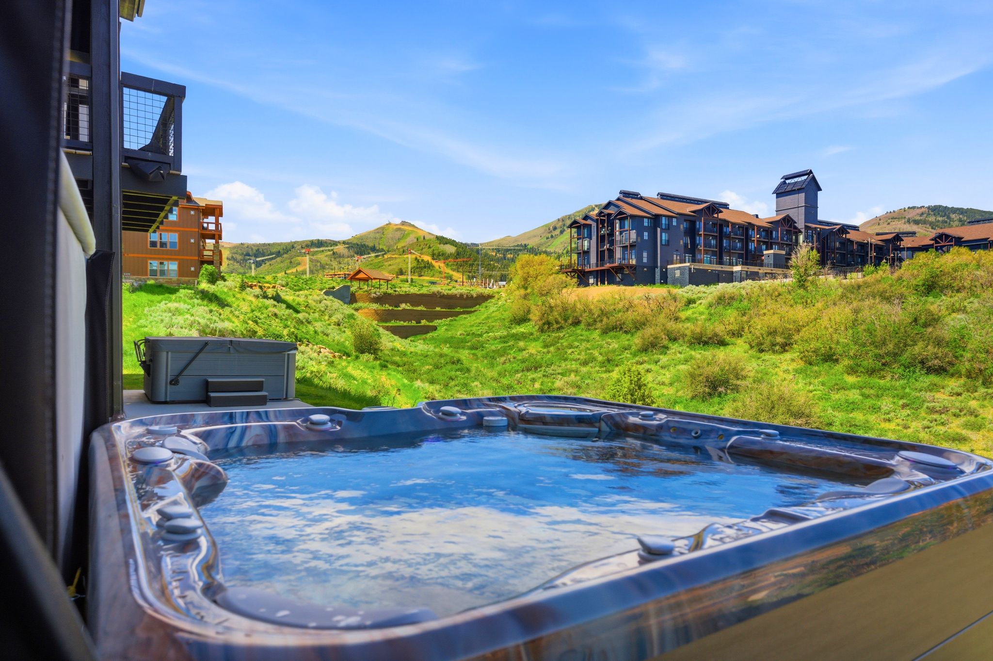 Outdoor hot tub featuring integrated seating and a serene water surface