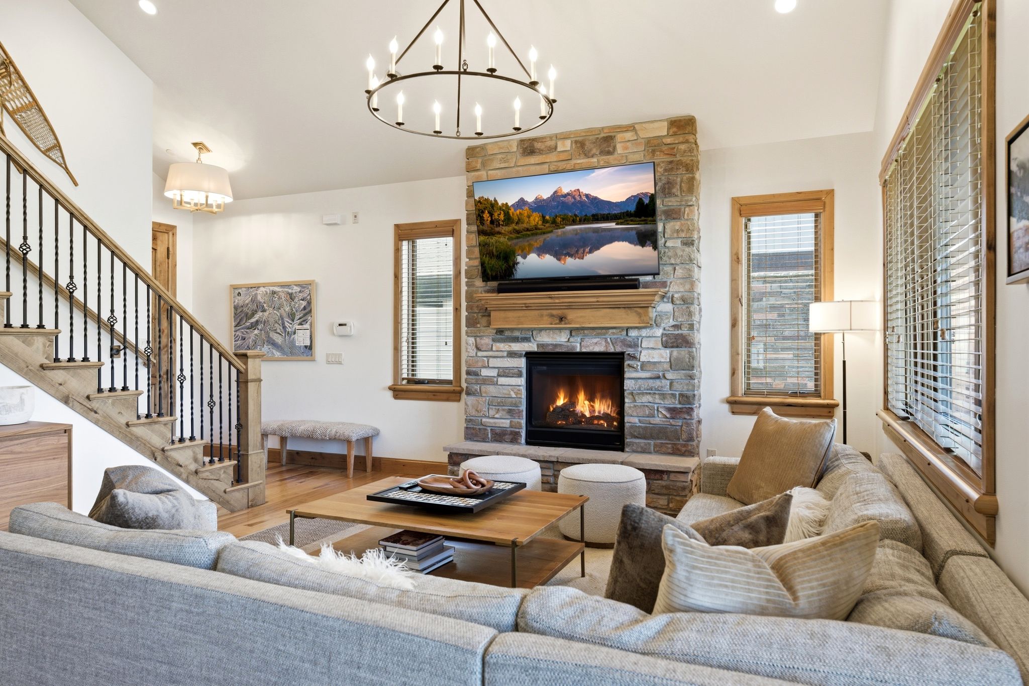 Living area featuring a floor-to-ceiling stone fireplace with a wood mantel