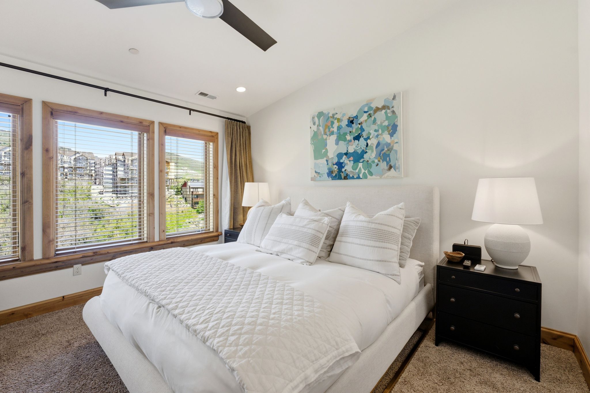 Bedroom featuring three large windows with wood trim, a ceiling fan, and recessed lighting