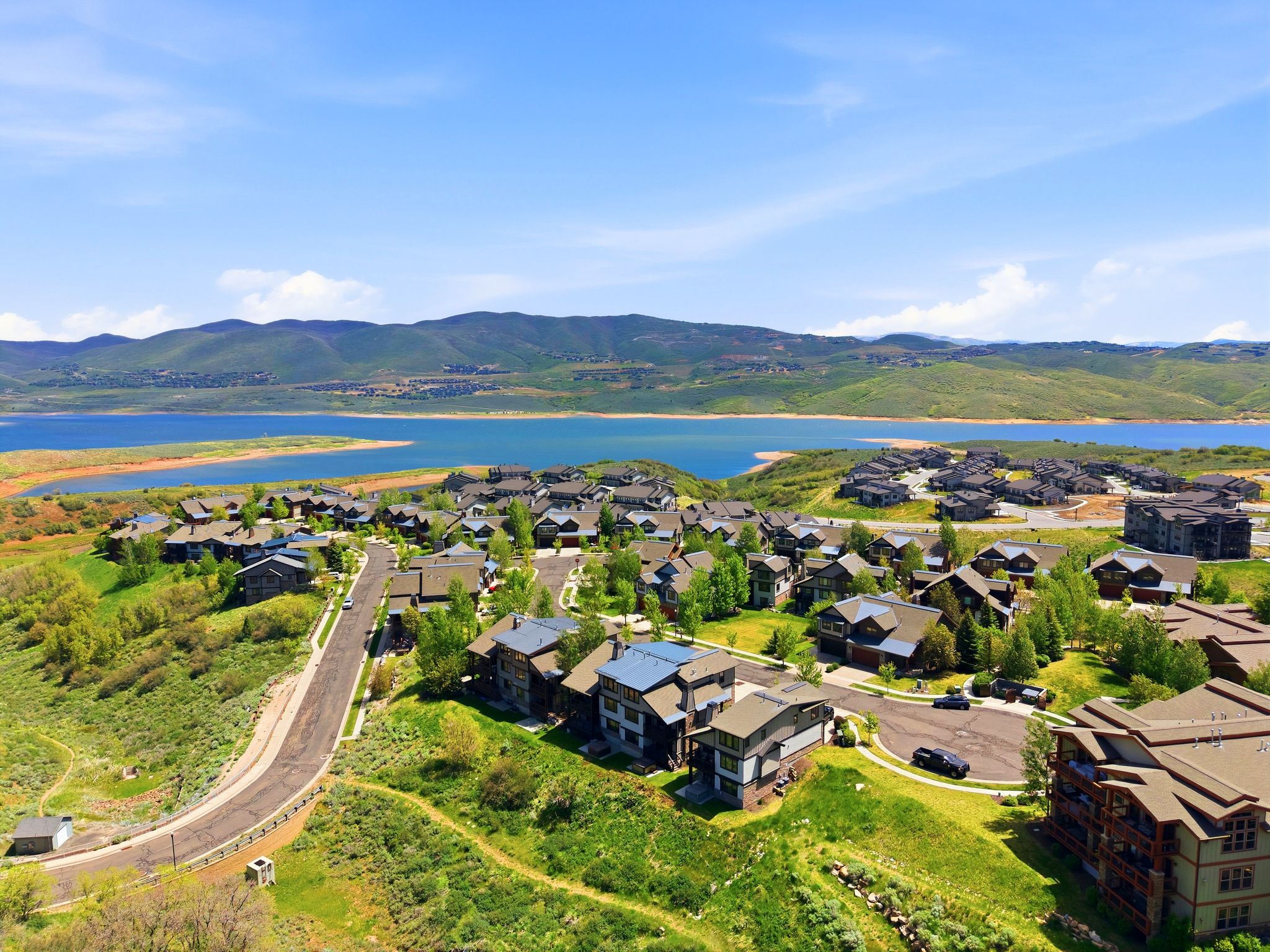 Expansive residential community featuring a prominent lake and mountain backdrop