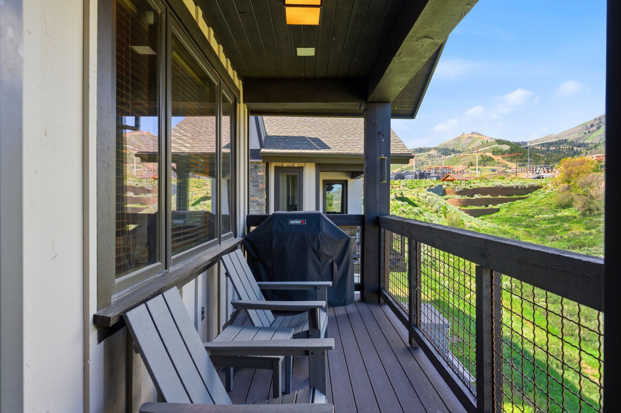 Expansive balcony featuring composite decking and a cable railing system