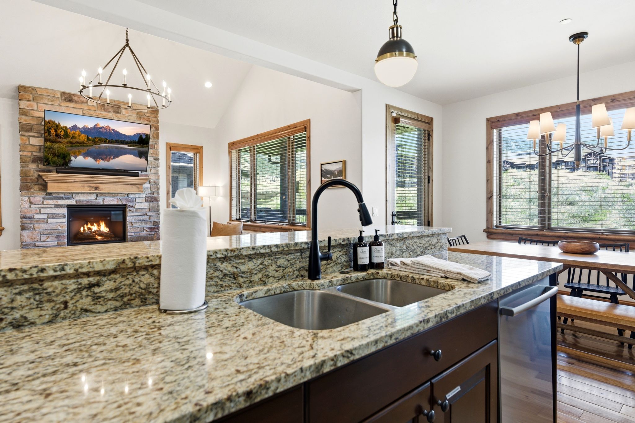 Kitchen island featuring a dual stainless steel sink and a contemporary black faucet