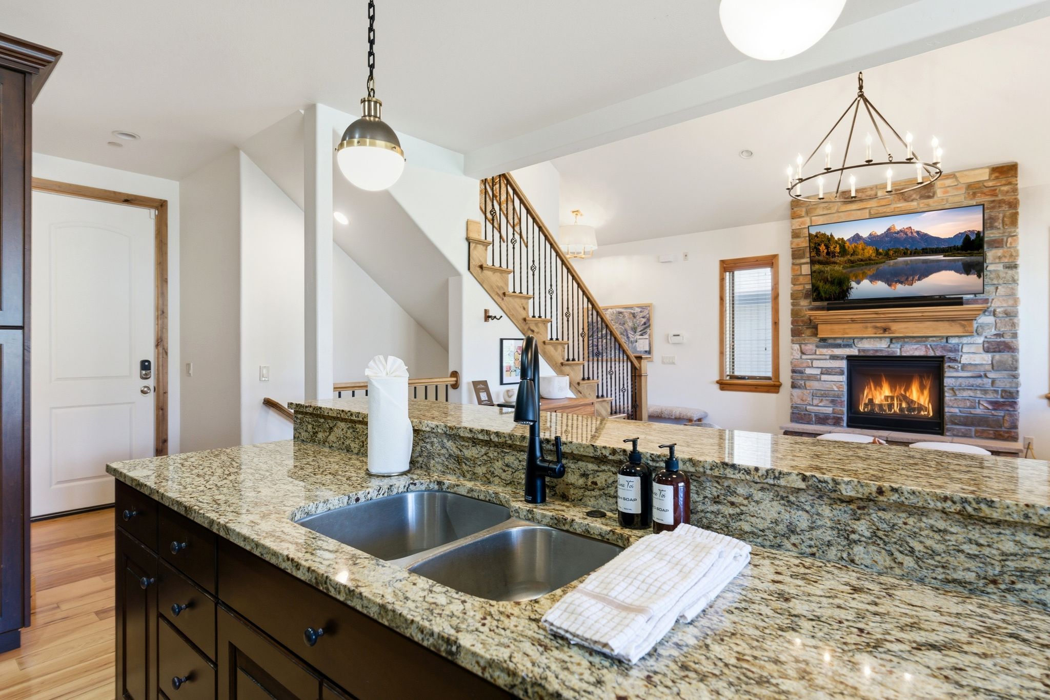 Kitchen island featuring a dual stainless steel sink and granite countertops