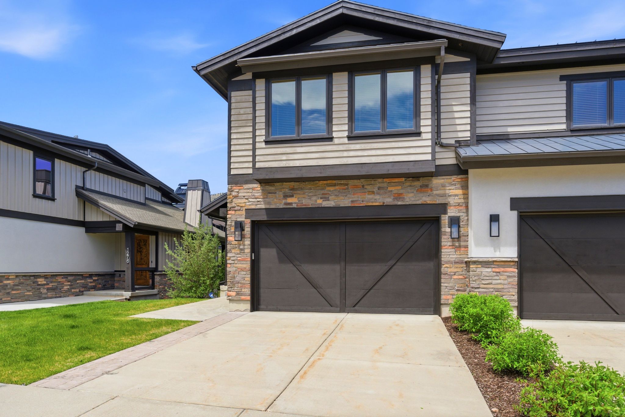 Contemporary exterior featuring stone veneer and horizontal siding