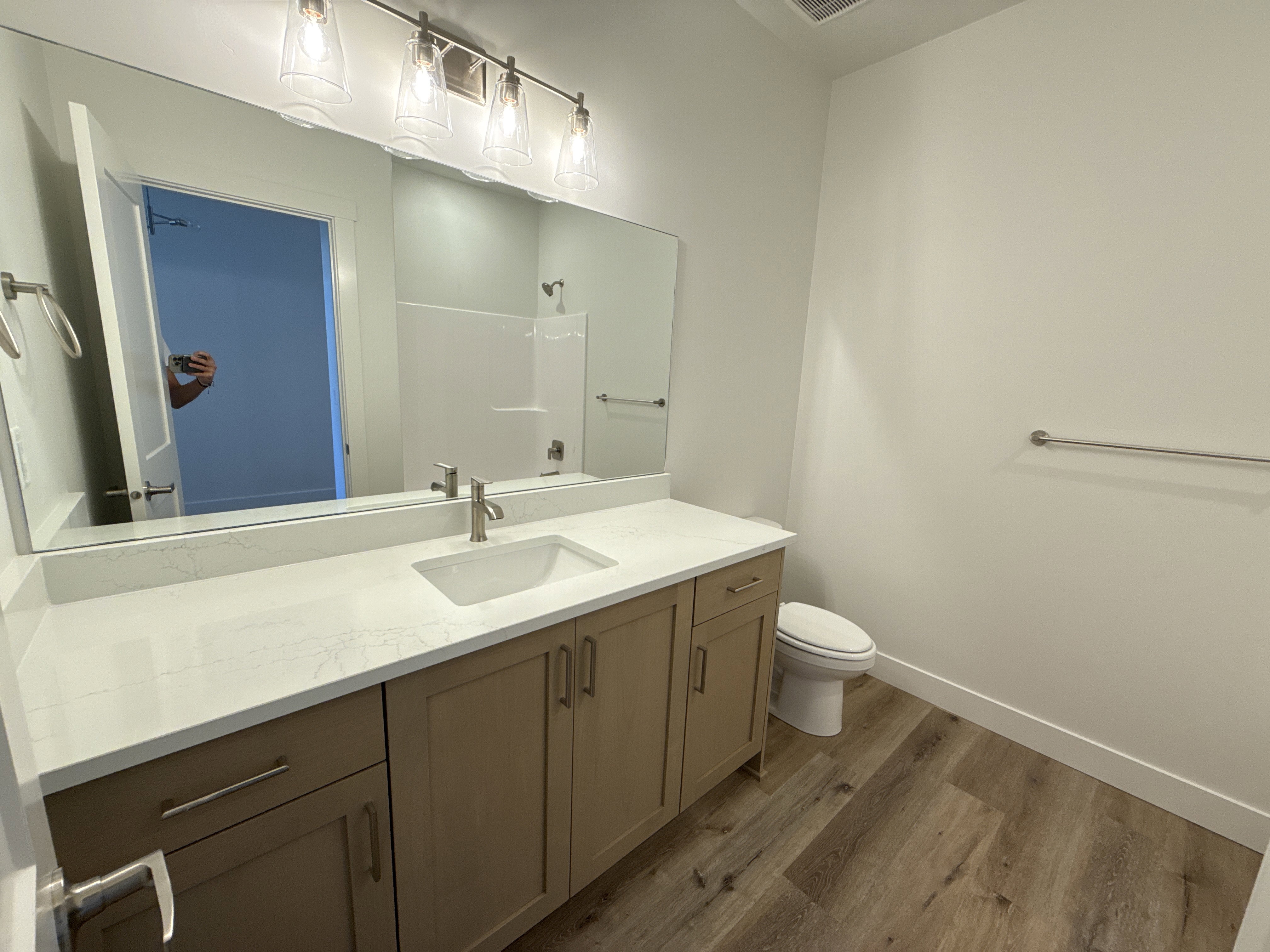 Bathroom featuring a light wood-finish vanity with a white countertop and integrated sink
