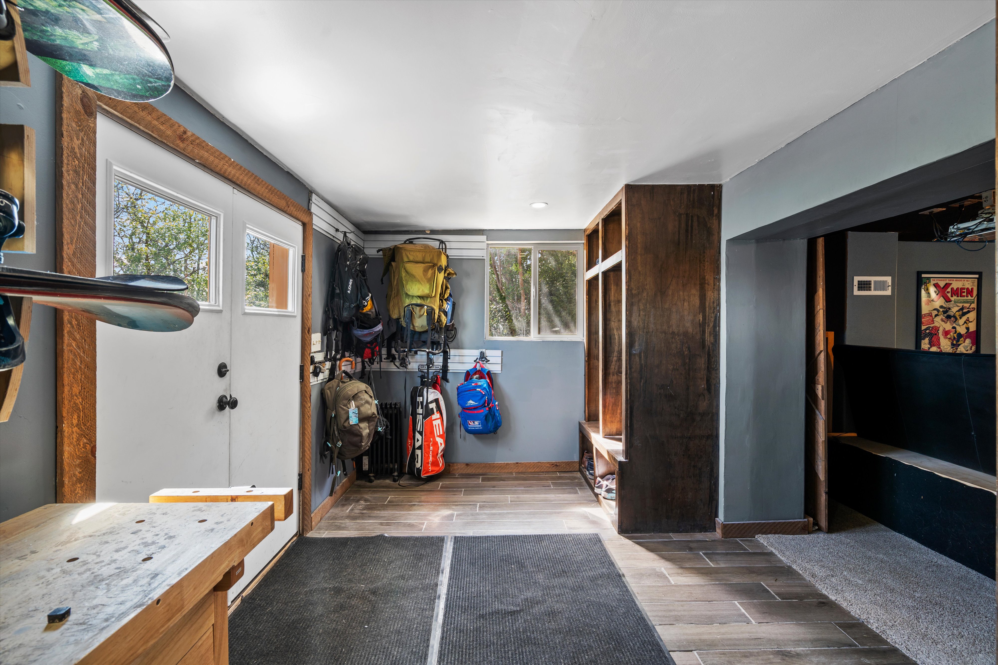 Entryway featuring wood-finish flooring and a built-in storage bench