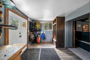 Entryway featuring wood-finish flooring and a built-in storage bench