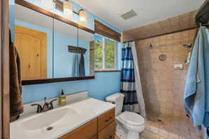 Bathroom vanity with a white countertop and wood-finish cabinetry