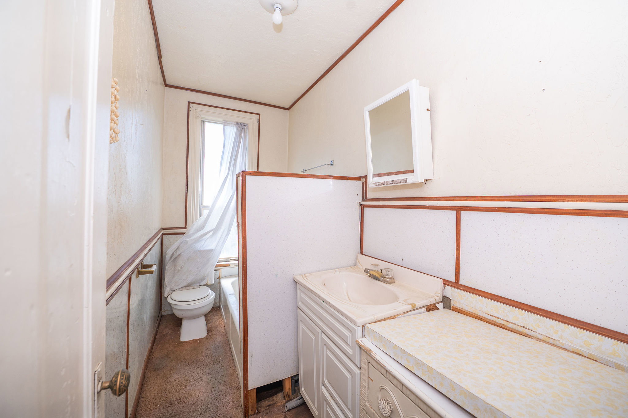 Bathroom featuring a built-in vanity with integrated sink, wall-mounted medicine cabinet, bathtub, and toilet