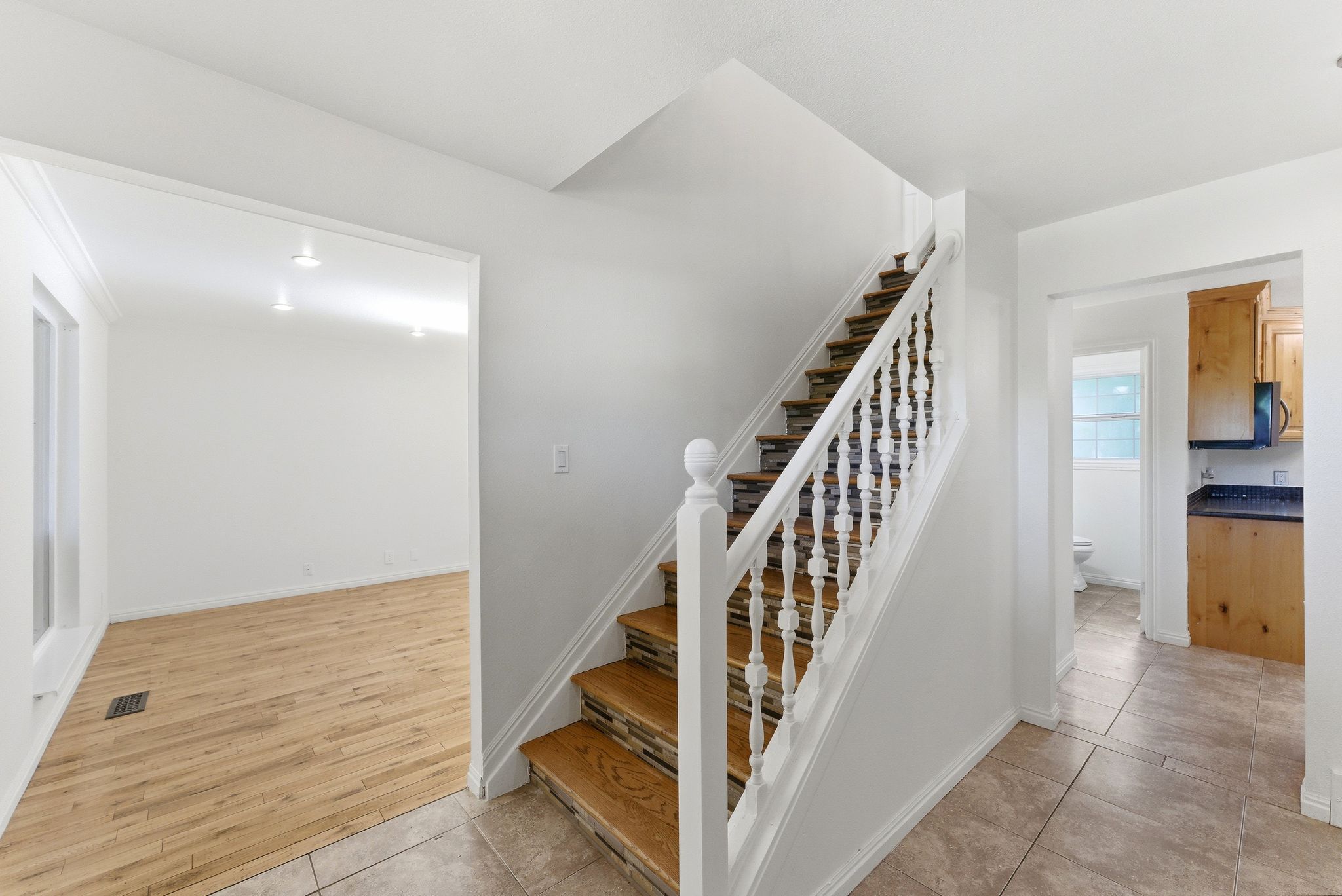 Entryway showing living room and kitchen access