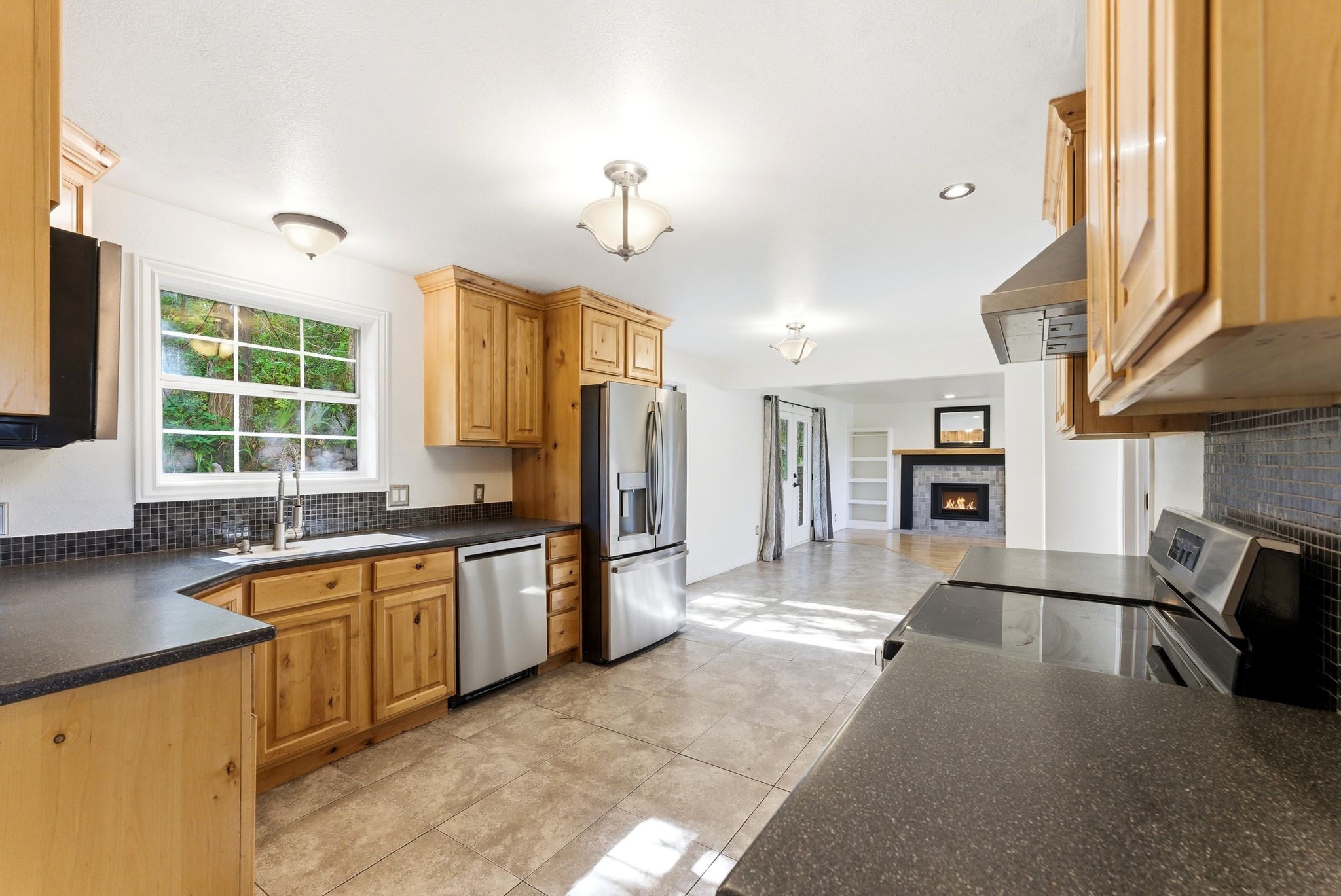 Kitchen featuring Alder wood cabinetry, stainless steel appliances, solid surface countertops