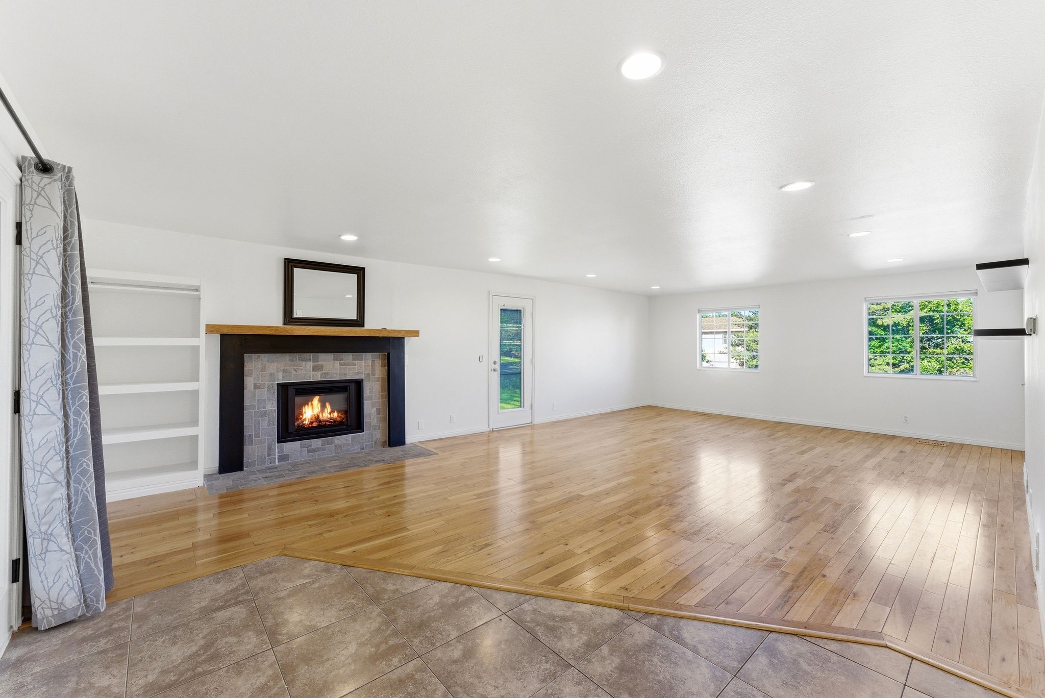 Spacious family room area right off kitchen featuring beautiful wood flooring and new electric  fireplace