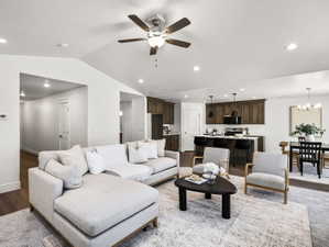 Open-concept living space featuring wood-finish flooring, recessed lighting, and a ceiling fan