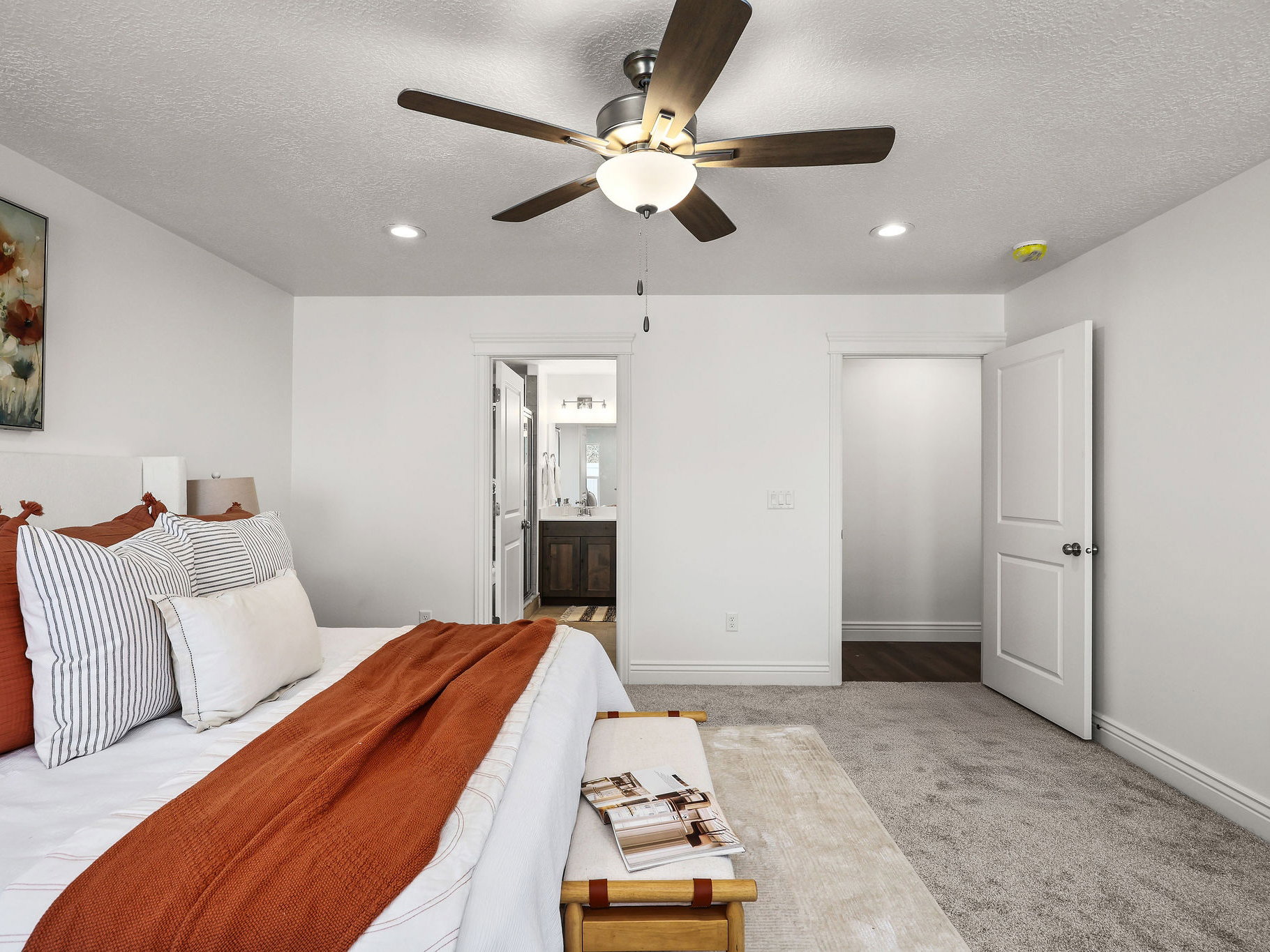 Carpeted room with a ceiling fan light fixture and recessed lighting